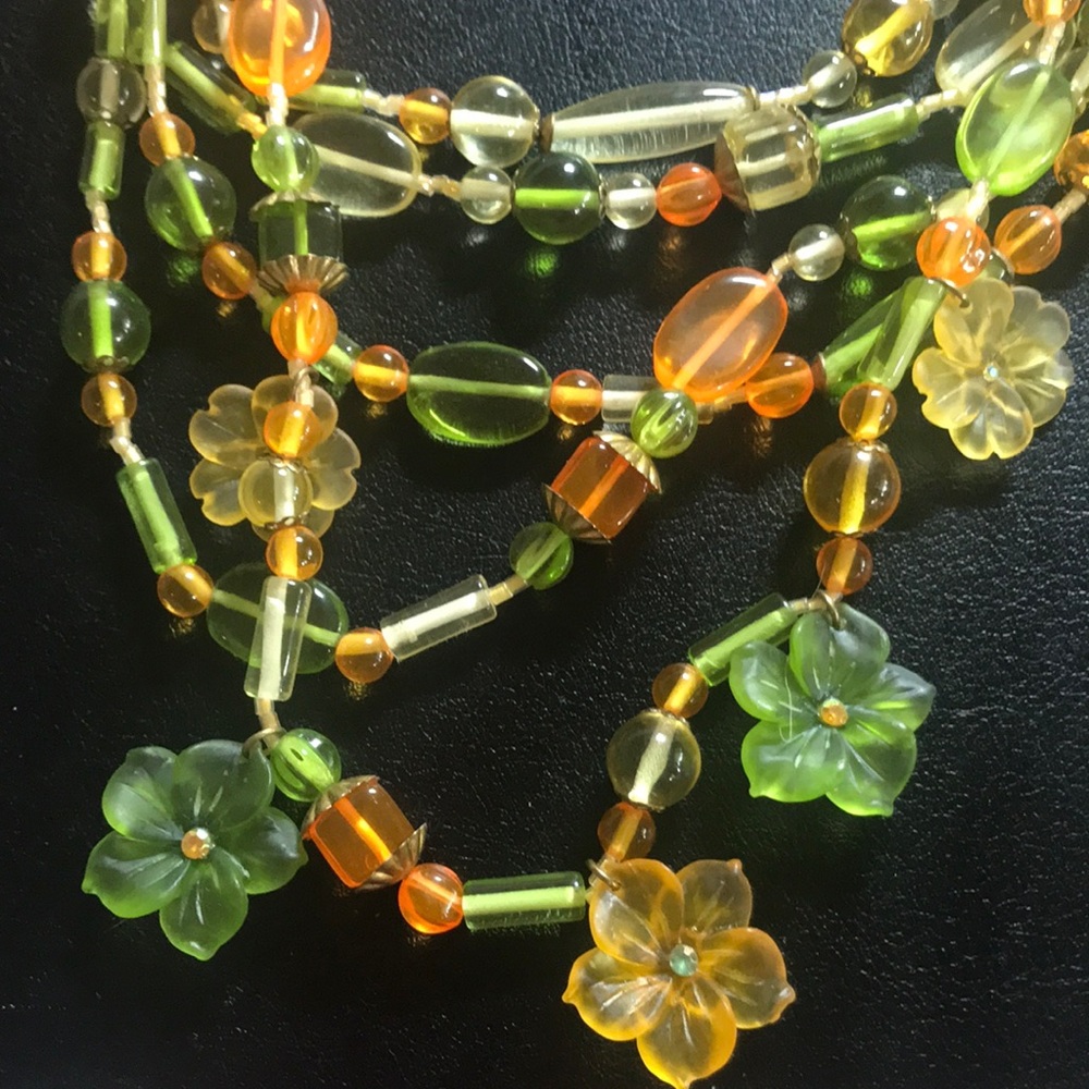 5 strand orange and green beaded necklace with flower details